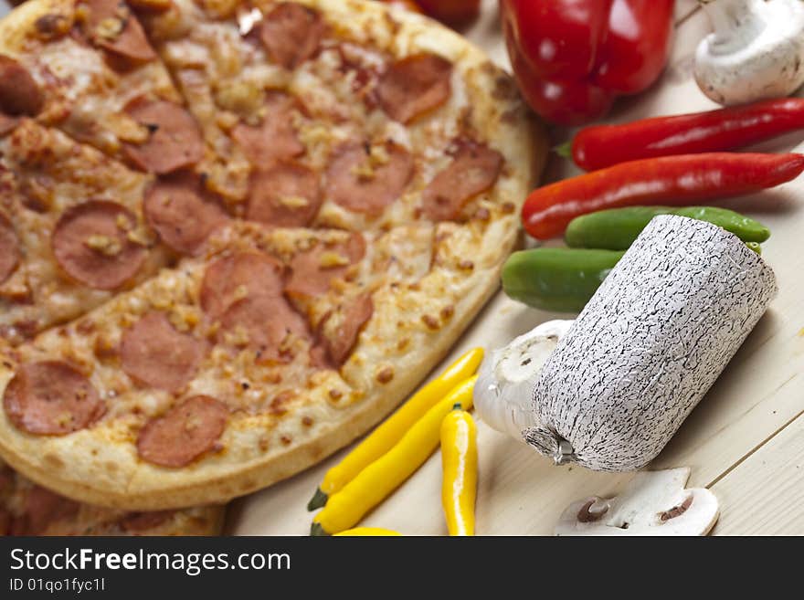 A couple of delicious pizzas, with raw tomatoes, green peppers and salami. A couple of delicious pizzas, with raw tomatoes, green peppers and salami