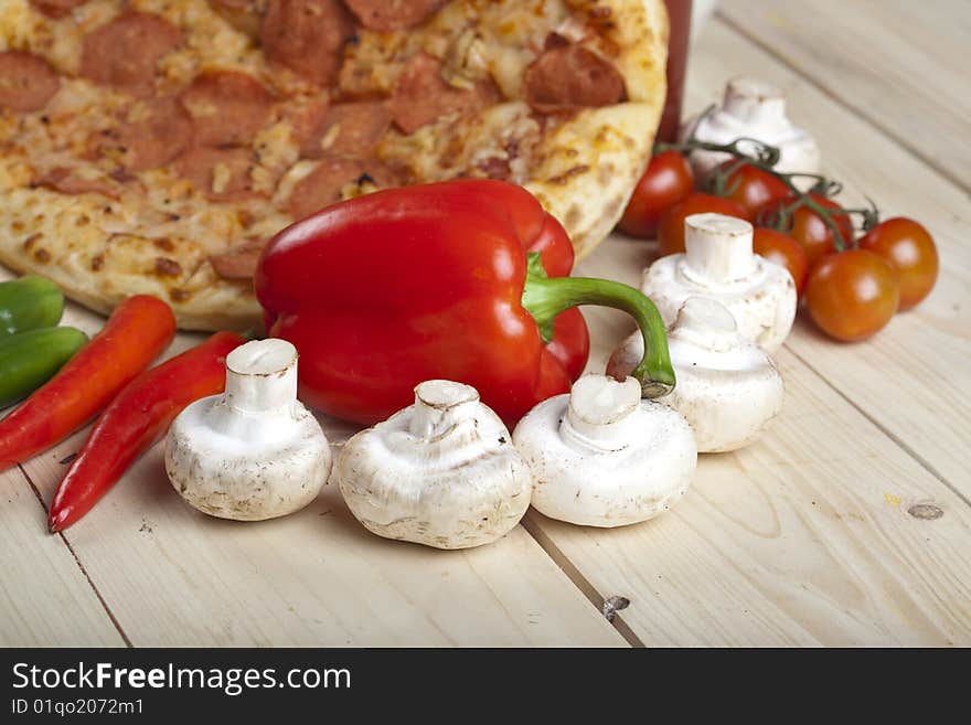 A couple of delicious pizzas, with raw tomatoes, green peppers and salami. A couple of delicious pizzas, with raw tomatoes, green peppers and salami