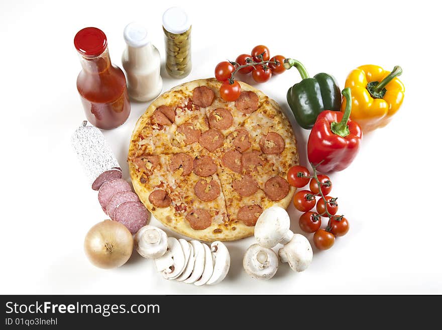 A couple of delicious pizzas, with raw tomatoes, green peppers and salami. A couple of delicious pizzas, with raw tomatoes, green peppers and salami