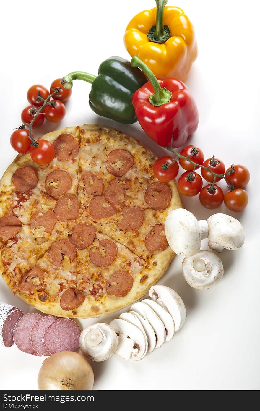 A couple of delicious pizzas, with raw tomatoes, green peppers and salami. A couple of delicious pizzas, with raw tomatoes, green peppers and salami