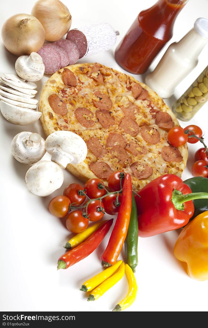 A couple of delicious pizzas, with raw tomatoes, green peppers and salami. A couple of delicious pizzas, with raw tomatoes, green peppers and salami