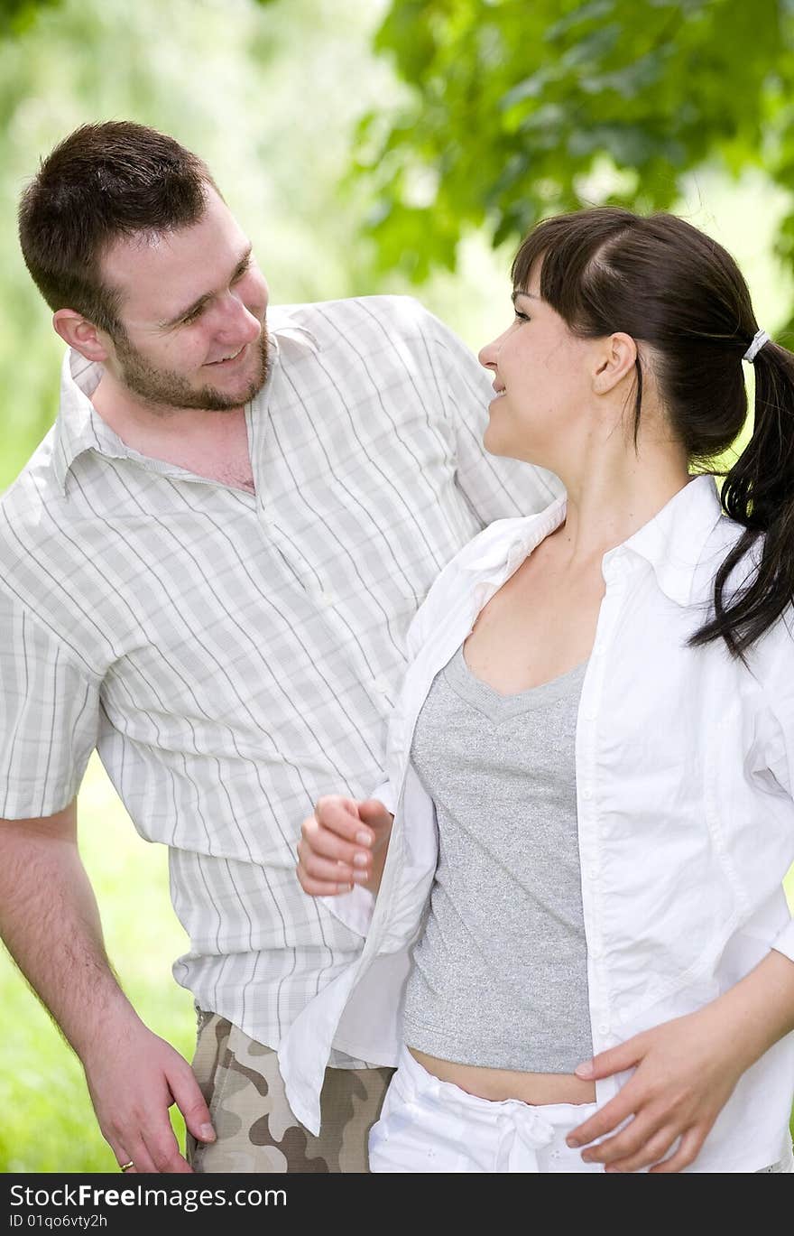 Happy couple together sitting on grass. Happy couple together sitting on grass