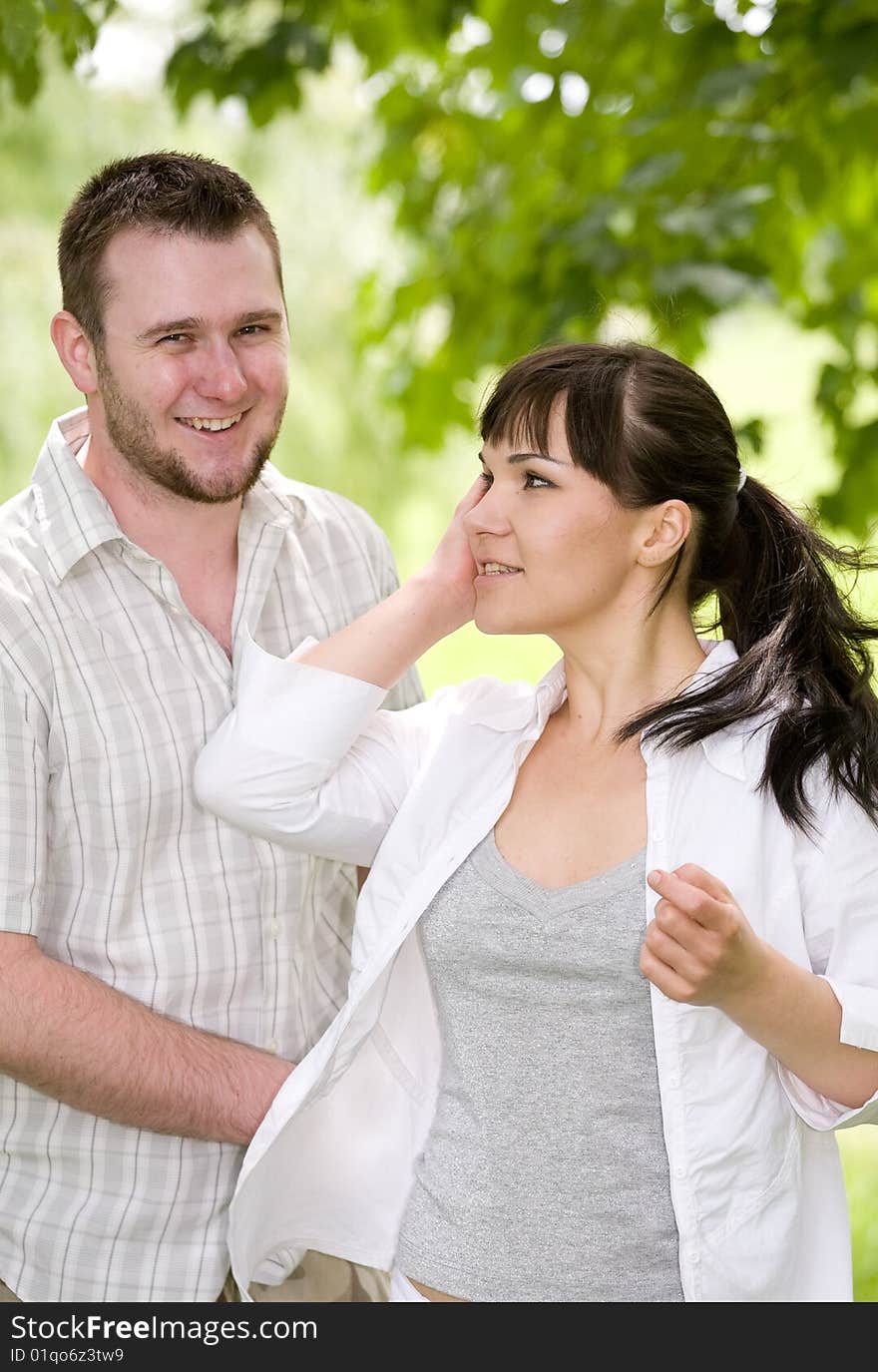 Happy couple together sitting on grass. Happy couple together sitting on grass