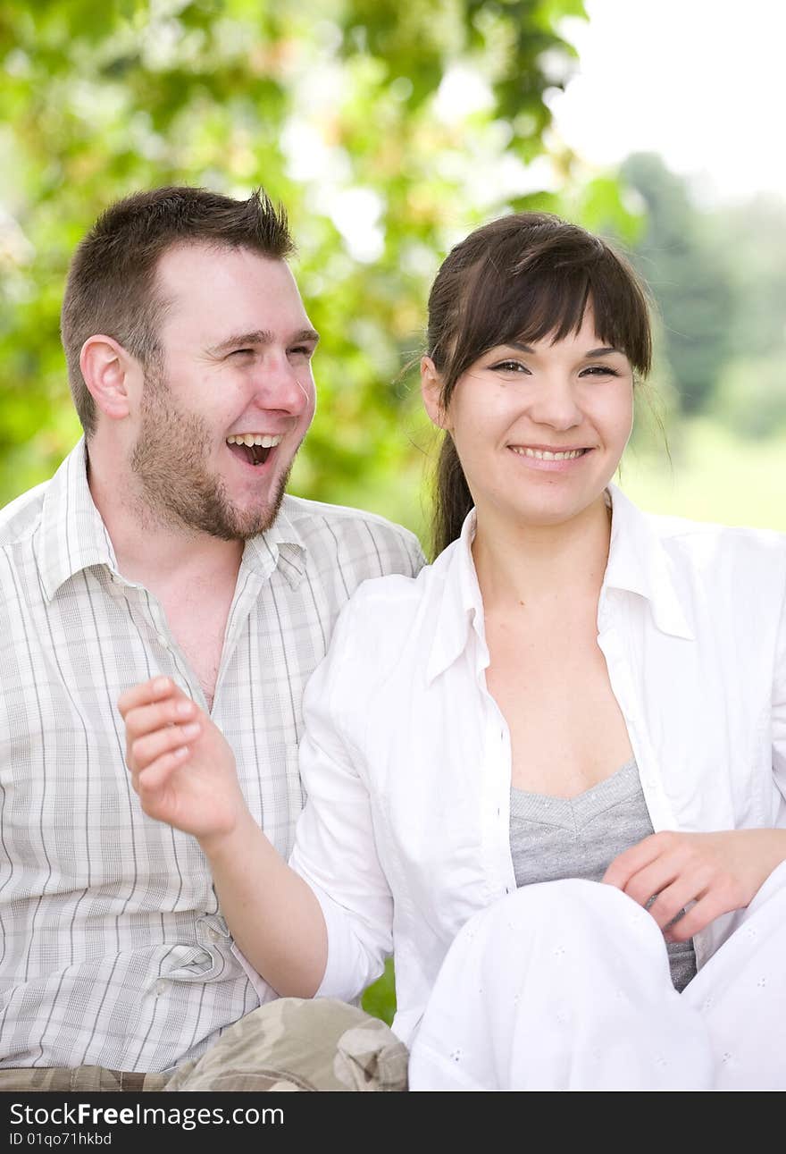 Happy couple together sitting on grass. Happy couple together sitting on grass