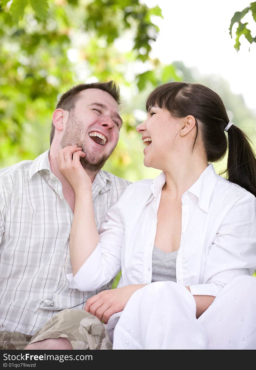 Happy couple together sitting on grass. Happy couple together sitting on grass