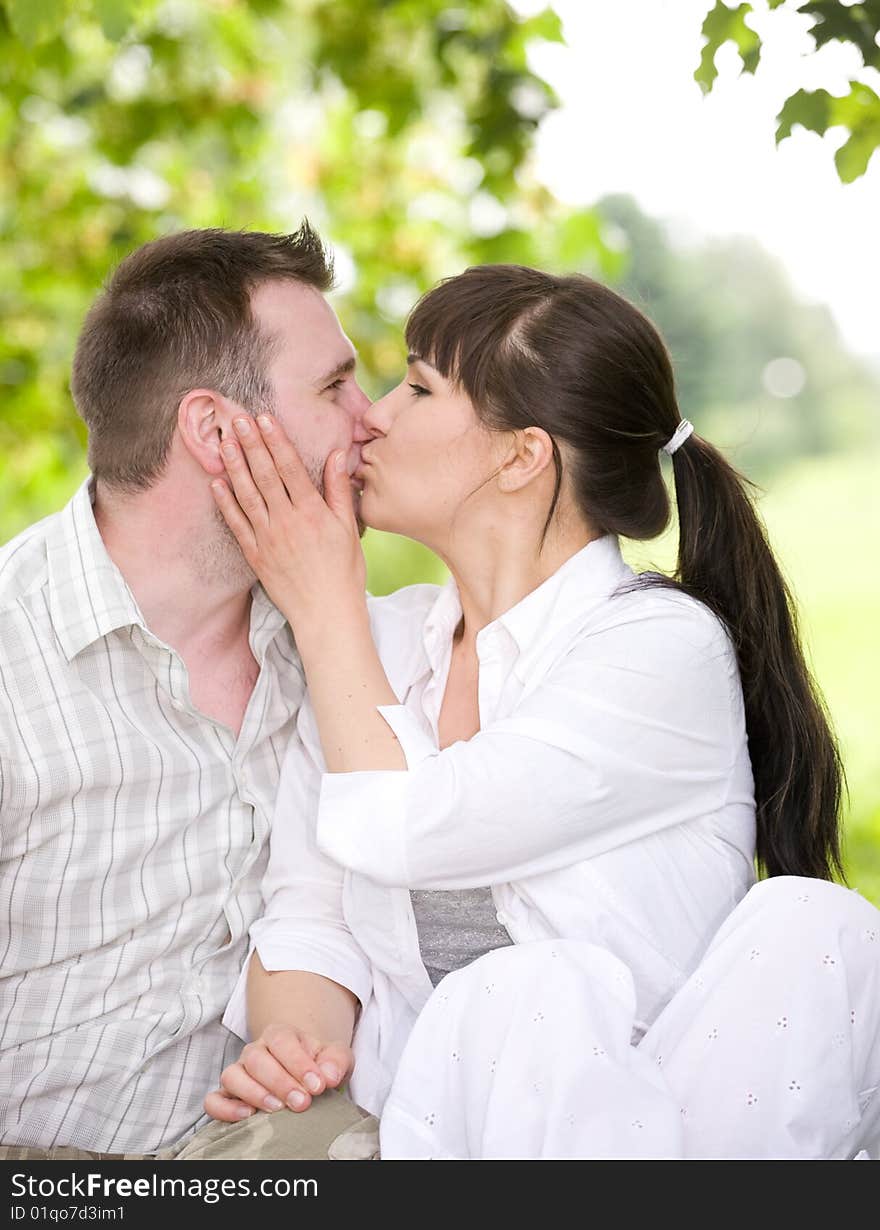 Happy couple together sitting on grass. Happy couple together sitting on grass