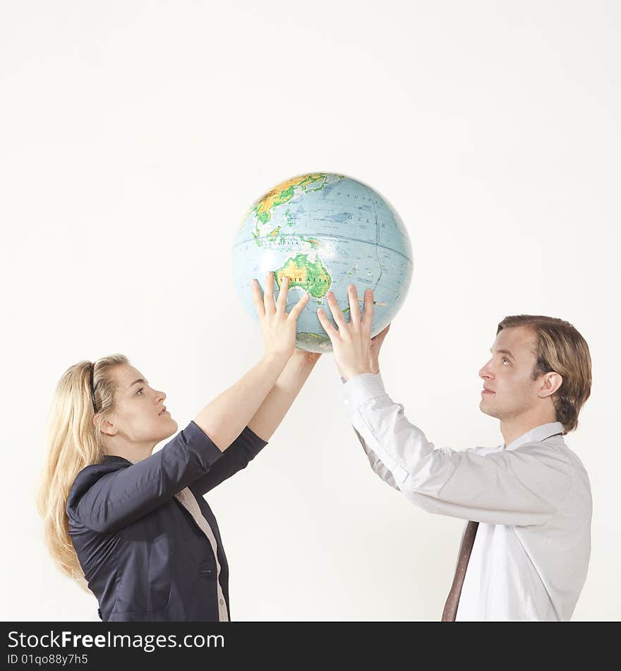 Male and female professional holding globe. Male and female professional holding globe