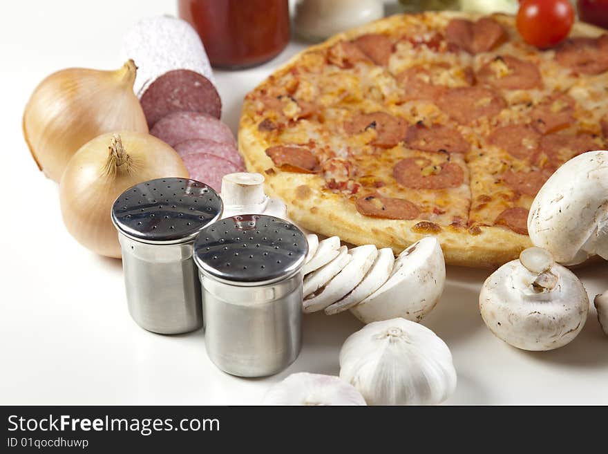 A couple of delicious pizzas, with raw tomatoes, green peppers and salami. A couple of delicious pizzas, with raw tomatoes, green peppers and salami