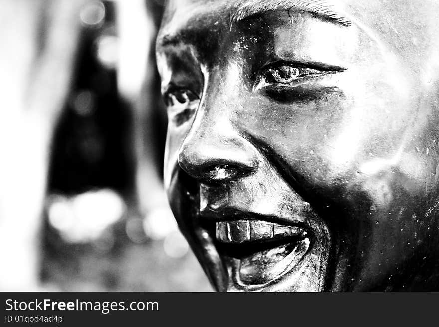 A sculpture of a young boy laughing