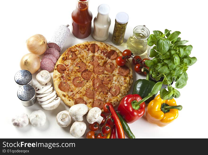 A couple of delicious pizzas, with raw tomatoes, green peppers and salami. A couple of delicious pizzas, with raw tomatoes, green peppers and salami