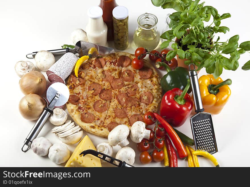 A couple of delicious pizzas, with raw tomatoes, green peppers and salami. A couple of delicious pizzas, with raw tomatoes, green peppers and salami