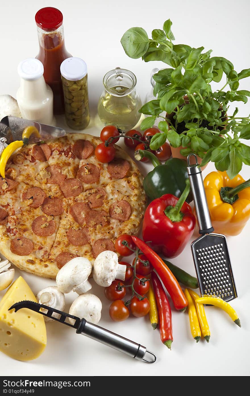 A couple of delicious pizzas, with raw tomatoes, green peppers and salami. A couple of delicious pizzas, with raw tomatoes, green peppers and salami