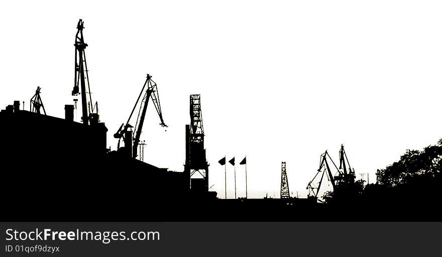 Silhouettes of Portal Cranes in a Harbor