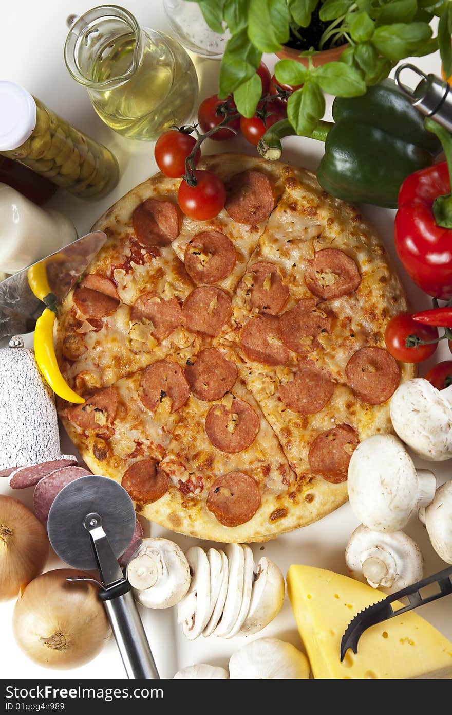 A couple of delicious pizzas, with raw tomatoes, green peppers and salami. A couple of delicious pizzas, with raw tomatoes, green peppers and salami