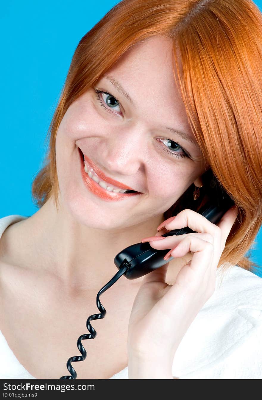 Closeup portrait of beautiful red girl with phone