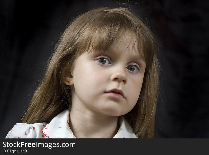 Adorable little pensive girl' portrait against black. Adorable little pensive girl' portrait against black