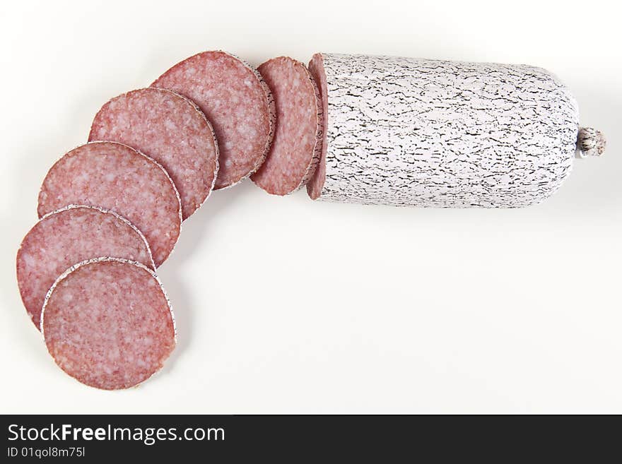 Macro picture of slice of salami isolated on white background