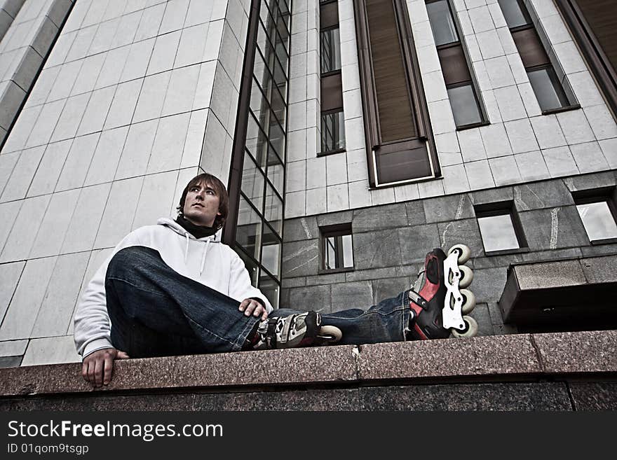 Wide angle portrait of a serious rollerskating man. Wide angle portrait of a serious rollerskating man