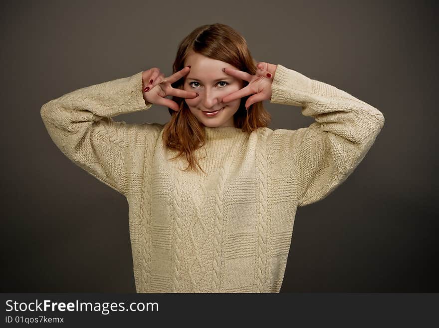 Smiling red haired girl in sweater isolated