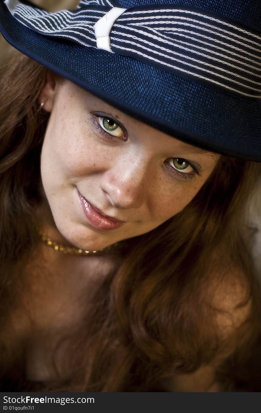 Head shot of a young, red haired lady wearing a blue hat. Head shot of a young, red haired lady wearing a blue hat.