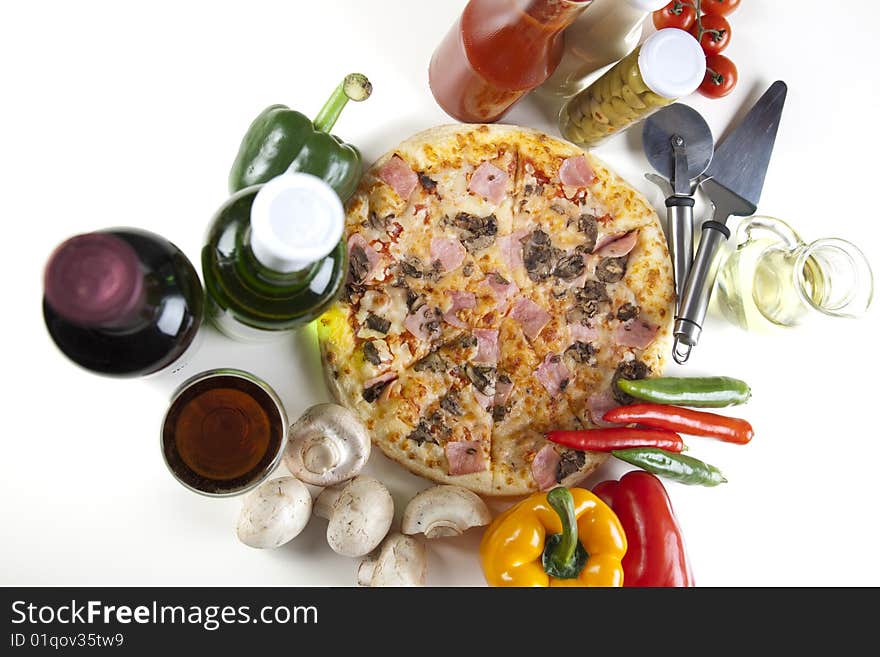 A couple of delicious pizzas, with raw tomatoes, green peppers and mushrooms. A couple of delicious pizzas, with raw tomatoes, green peppers and mushrooms