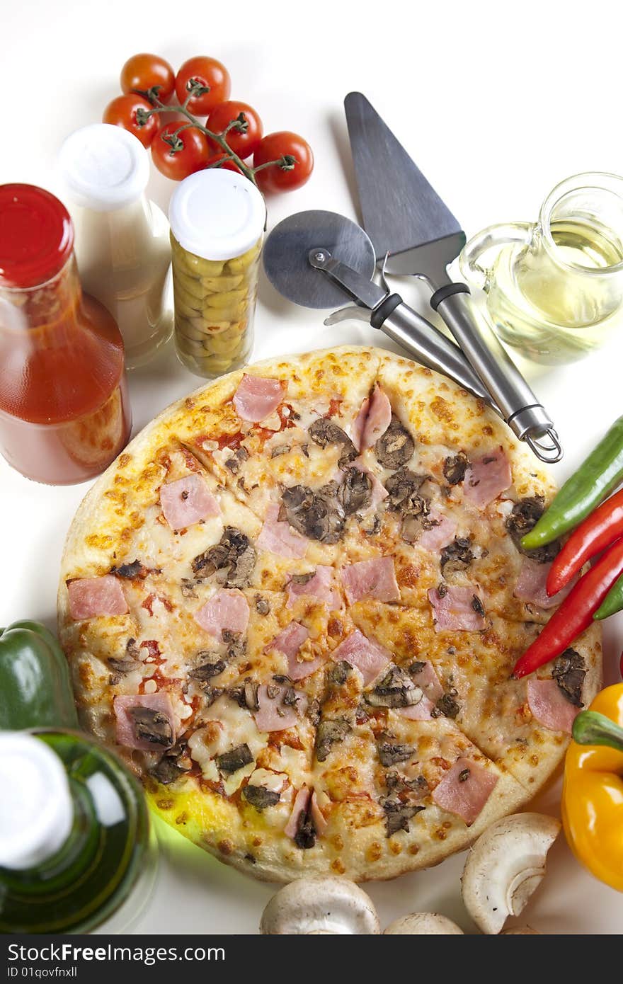 A couple of delicious pizzas, with raw tomatoes, green peppers and mushrooms. A couple of delicious pizzas, with raw tomatoes, green peppers and mushrooms