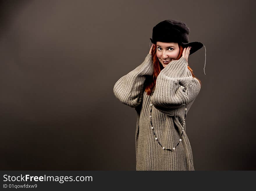 Woman in winter hat smiling towards to camera isolated