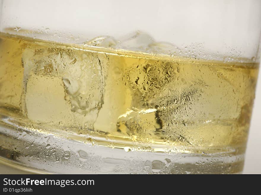 Closeup of a drink in a glass with ice cubes