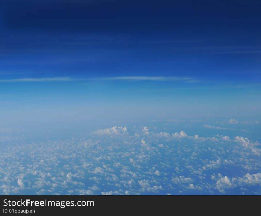 A bright blue sky with puffy white clouds. A bright blue sky with puffy white clouds.