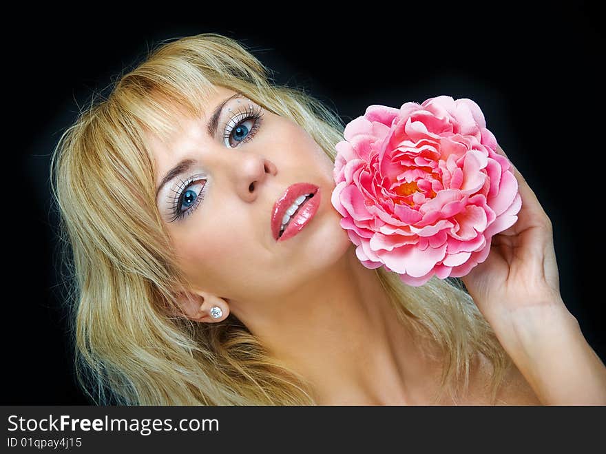 Portrait of young woman with flower on black background. Portrait of young woman with flower on black background