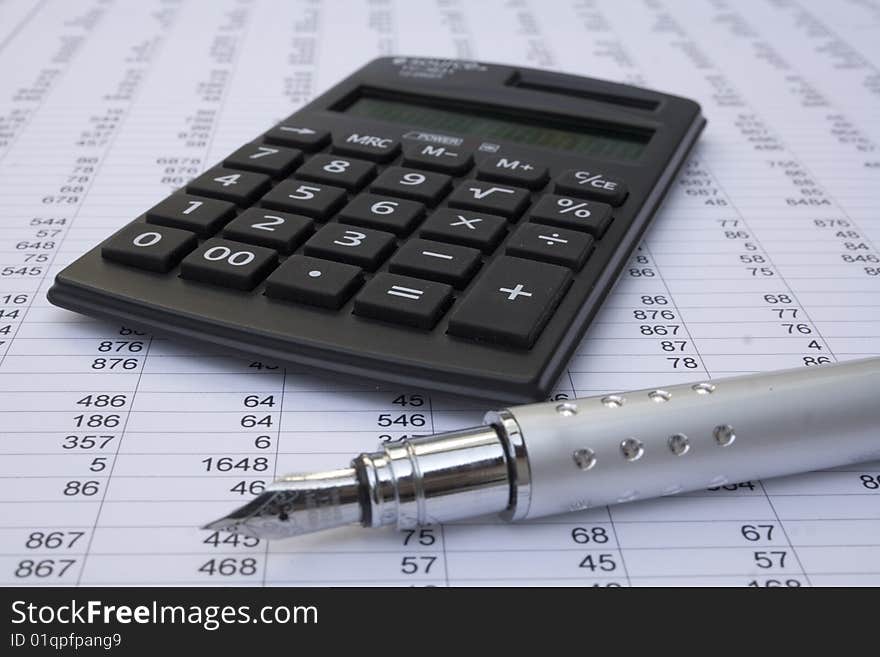 Calculator and pen on a white background. Calculator and pen on a white background