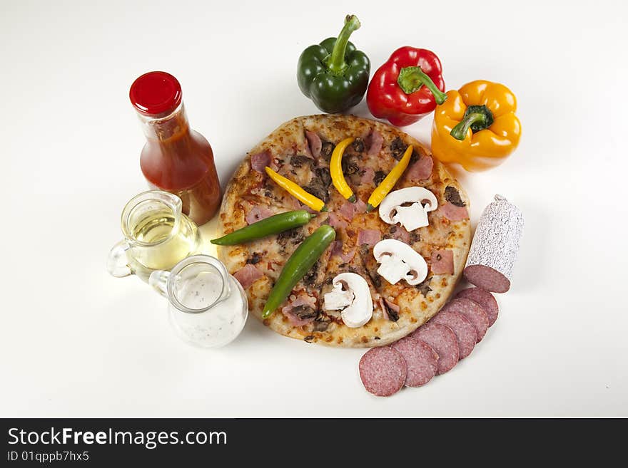 A couple of delicious pizzas, with raw tomatoes, green peppers and mushrooms. A couple of delicious pizzas, with raw tomatoes, green peppers and mushrooms