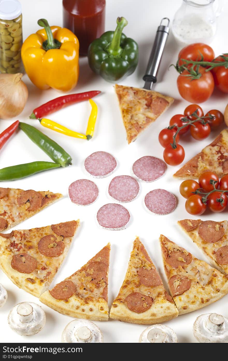 A couple of delicious pizzas, with raw tomatoes, green peppers and salami. A couple of delicious pizzas, with raw tomatoes, green peppers and salami