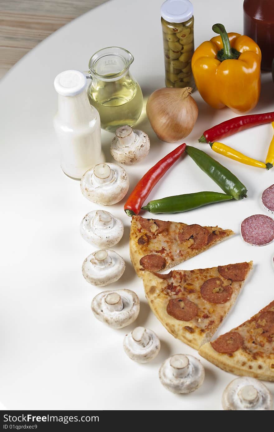 A couple of delicious pizzas, with raw tomatoes, green peppers and salami. A couple of delicious pizzas, with raw tomatoes, green peppers and salami