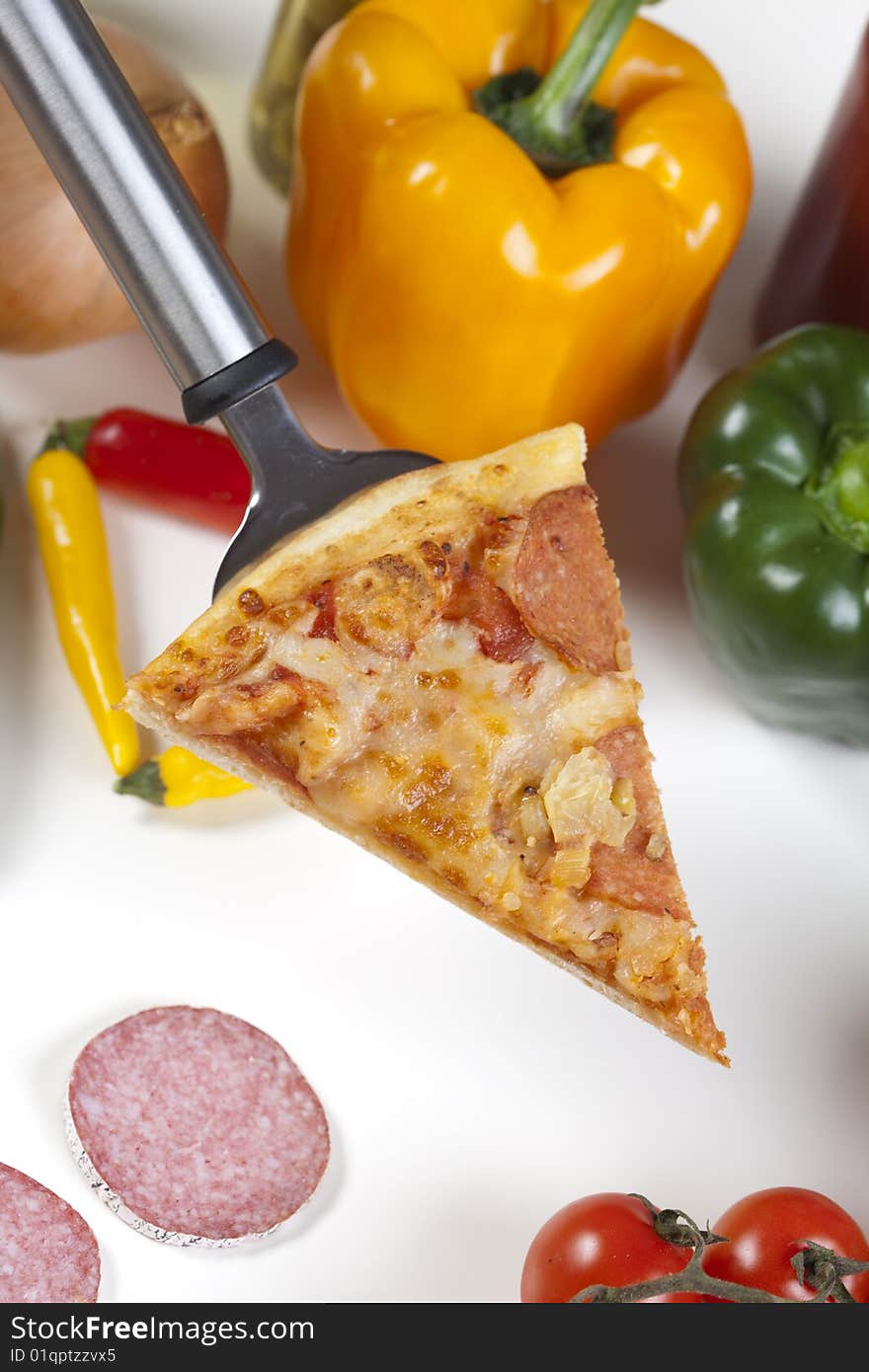 A couple of delicious pizzas, with raw tomatoes, green peppers and salami. A couple of delicious pizzas, with raw tomatoes, green peppers and salami