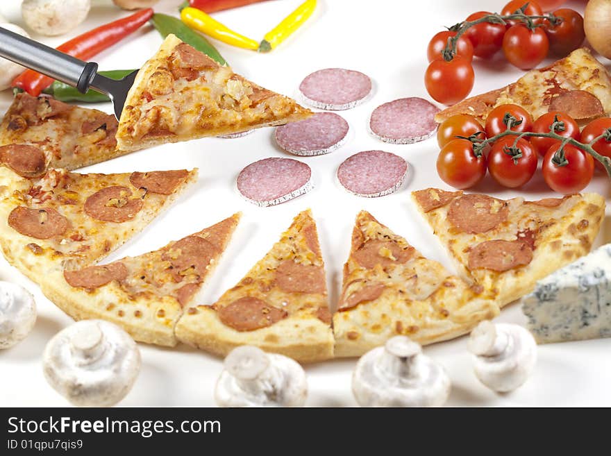 A couple of delicious pizzas, with raw tomatoes, green peppers and salami. A couple of delicious pizzas, with raw tomatoes, green peppers and salami