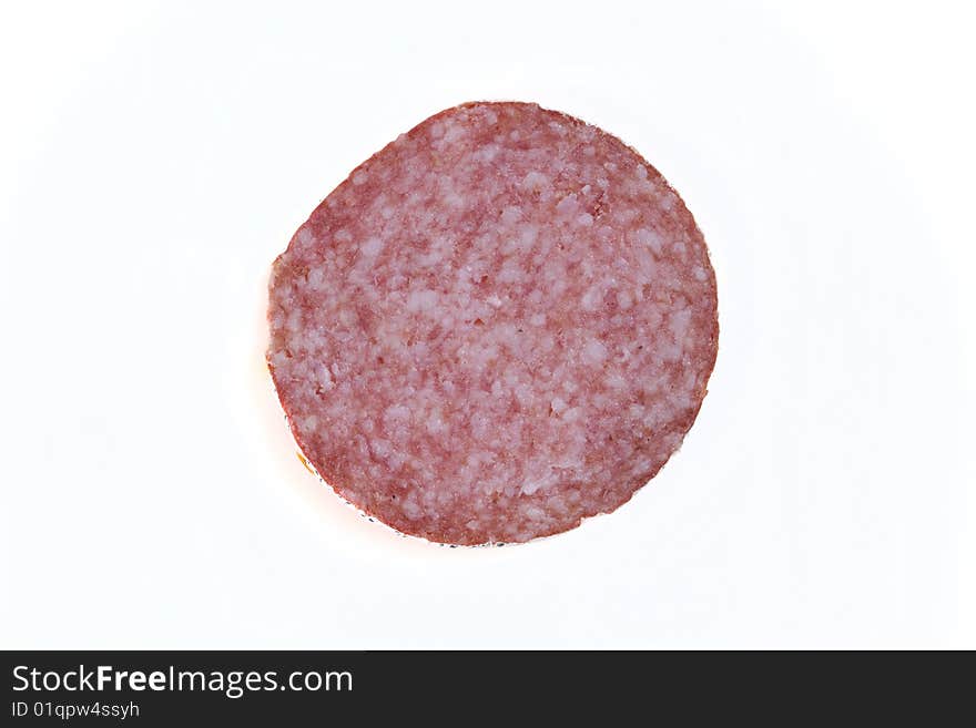 Macro picture of slice of salami isolated on white background