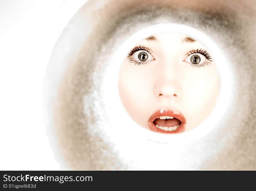 Woman looks through a pipe