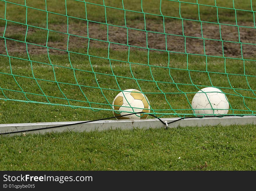 Two soccer balls in a goal. Two soccer balls in a goal