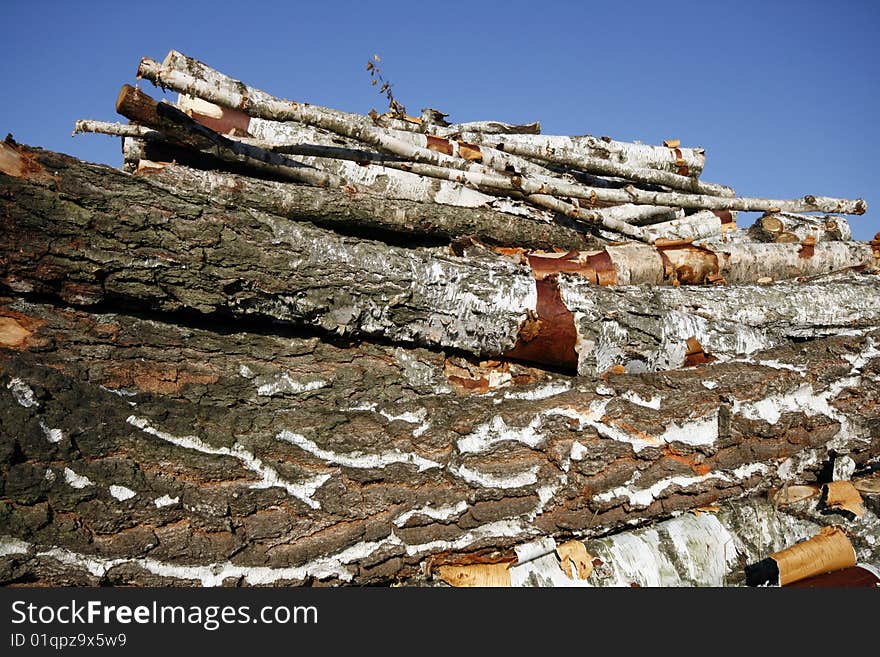 Stack of chopped wood on a wood yard in Upper Silesia, Poland. Pile of birch trees. Stack of chopped wood on a wood yard in Upper Silesia, Poland. Pile of birch trees.