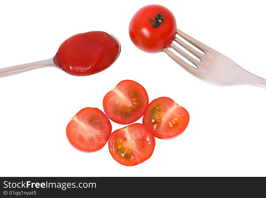 Detail of tomato with spoon and fork. Detail of tomato with spoon and fork