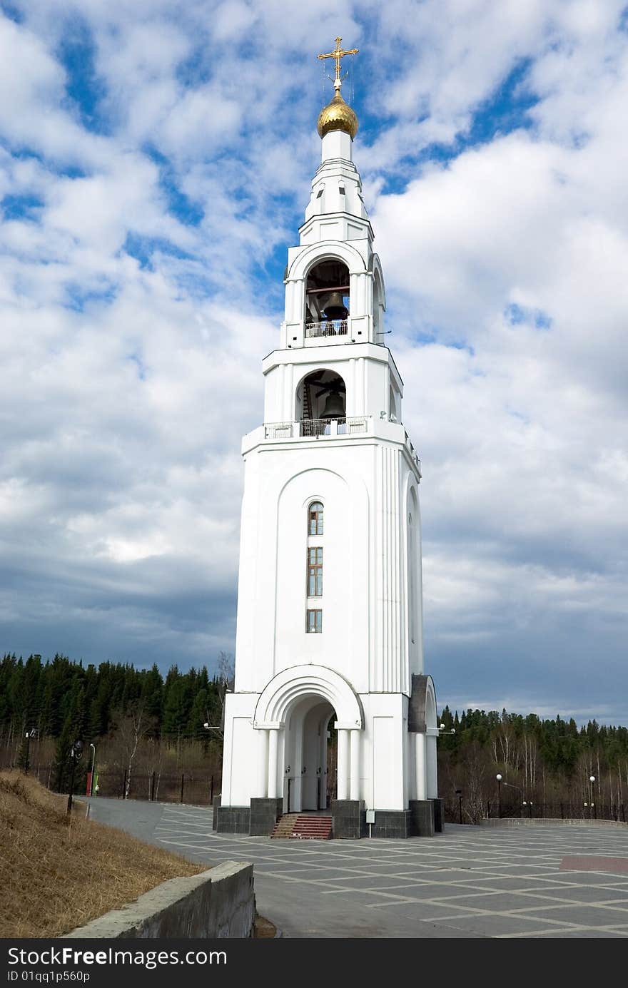 Kind on a belfry on a background of the cloudy sky