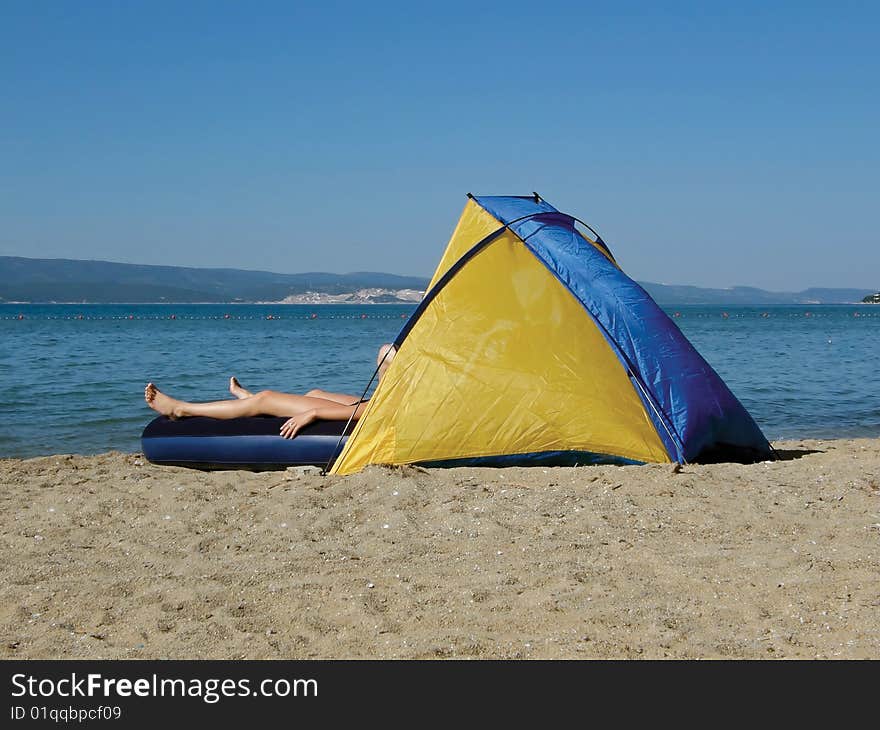 Woman on mattress in camp house. Woman on mattress in camp house