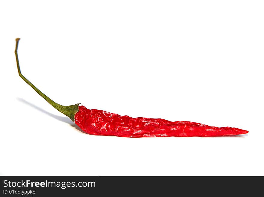 An image of a red chilli over white background