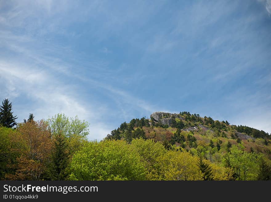 Vista view of North Carolina mountains near the Blue Ridge Parkway with blue cloudy skies. Vista view of North Carolina mountains near the Blue Ridge Parkway with blue cloudy skies