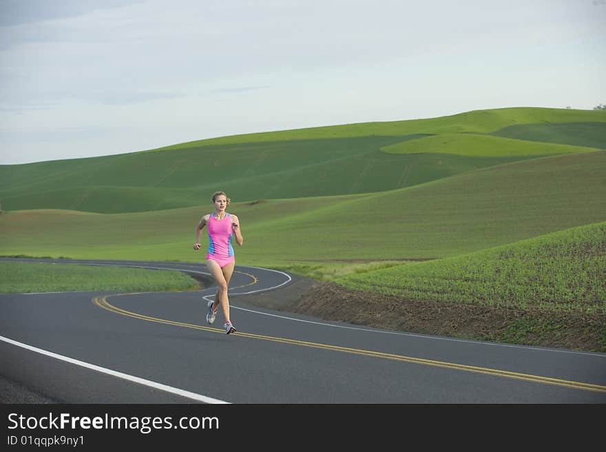Runner on rural road in farm land