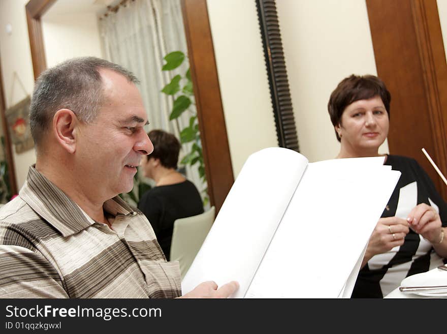 The man reading a menu in a restaurant. The man reading a menu in a restaurant