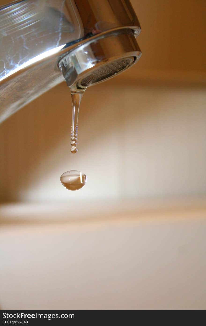 Droplet falling from a faucet.