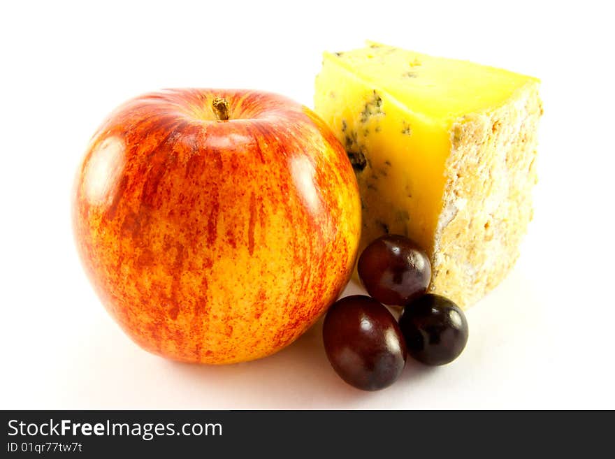 Single red apple with slice of blue cheese and grapes with clipping path on a white background. Single red apple with slice of blue cheese and grapes with clipping path on a white background