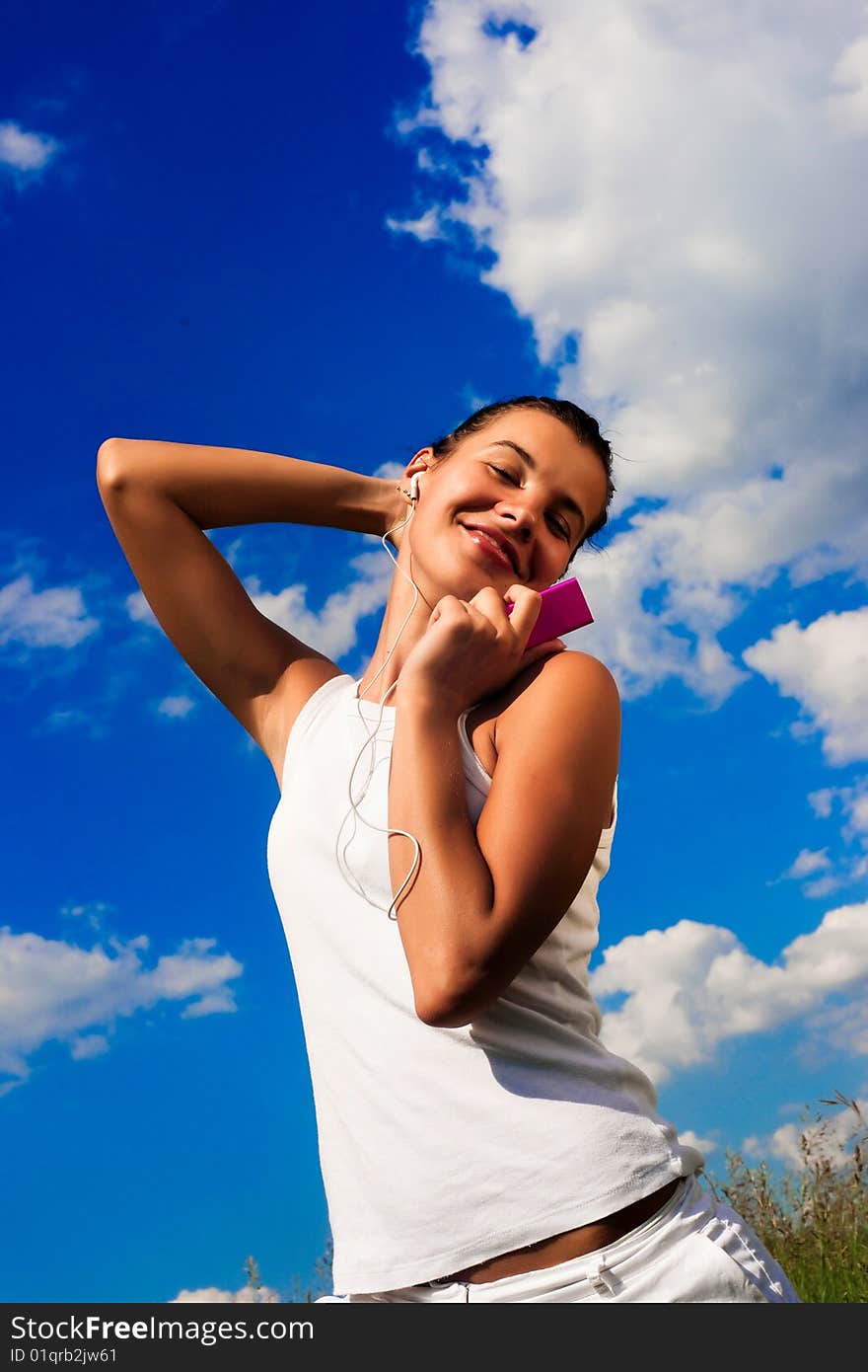 Pretty young girl listening music